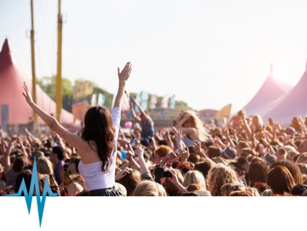 outdoor festival with people waving hands on a sunny day - scotia radio services spring summer radio hire 2024